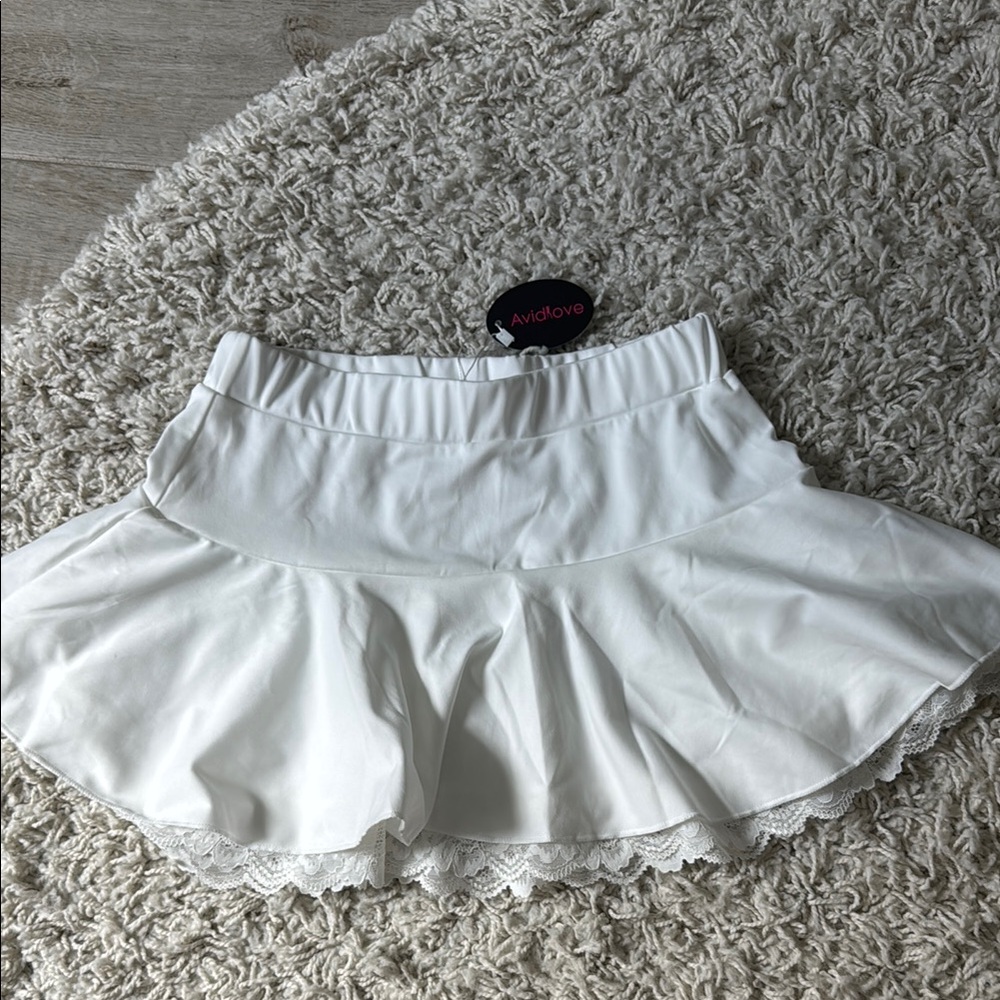 White mini skater skirt with ruffled high-low design for casual occasions
